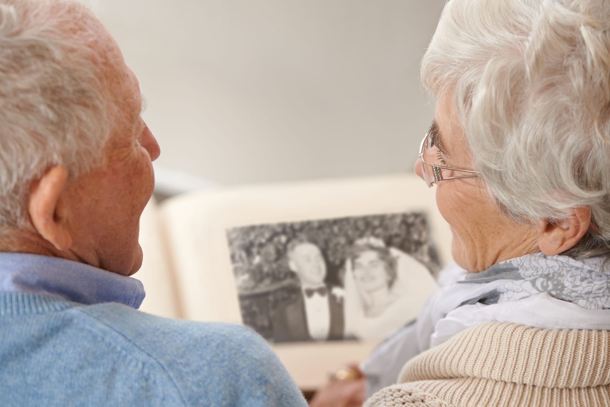 An older couple looking at memories of their wedding