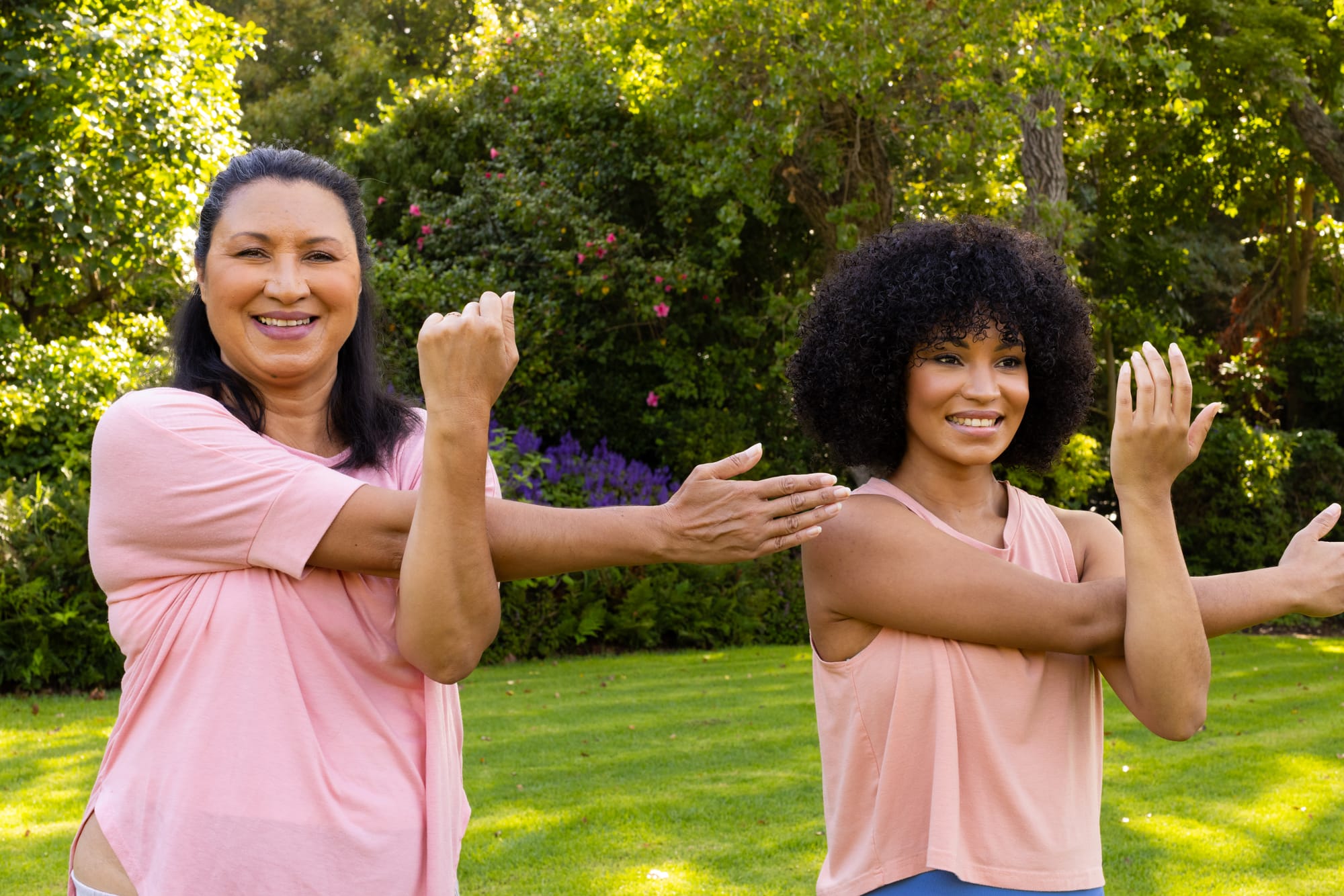 a young woman and old woman exercising in the park