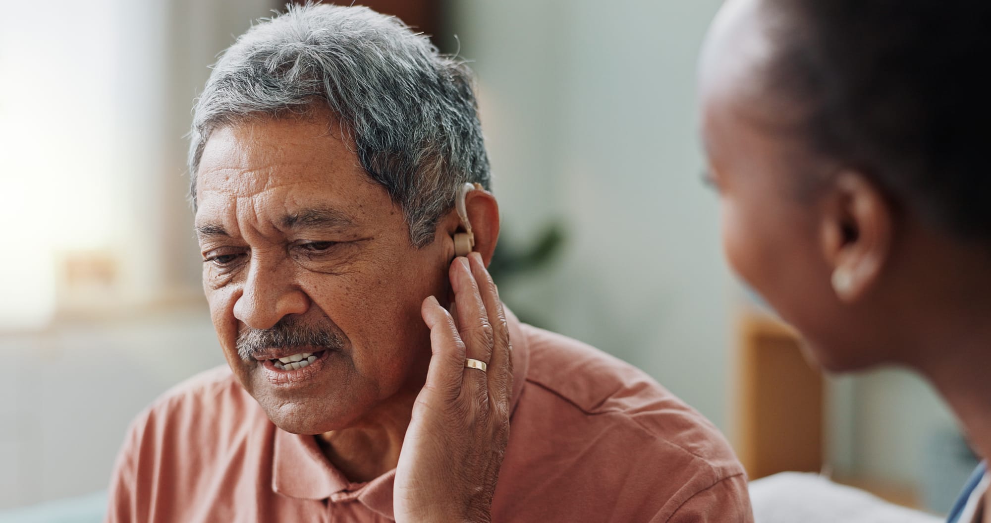 an older man getting fitted for hearing aids