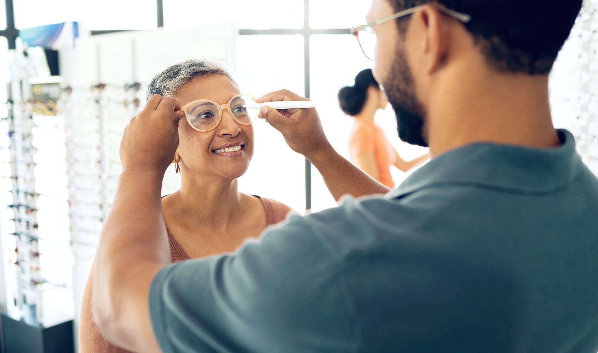 a woman getting fitted for glasses