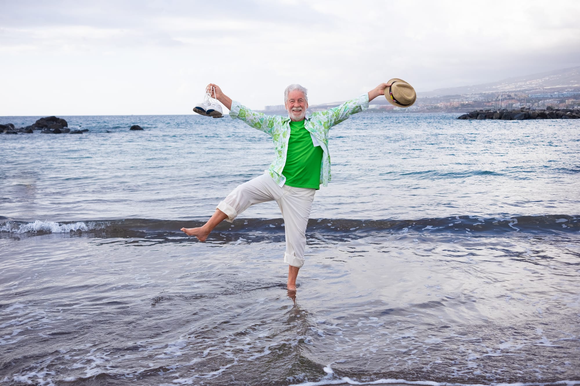 a well balanced older man at the ocean