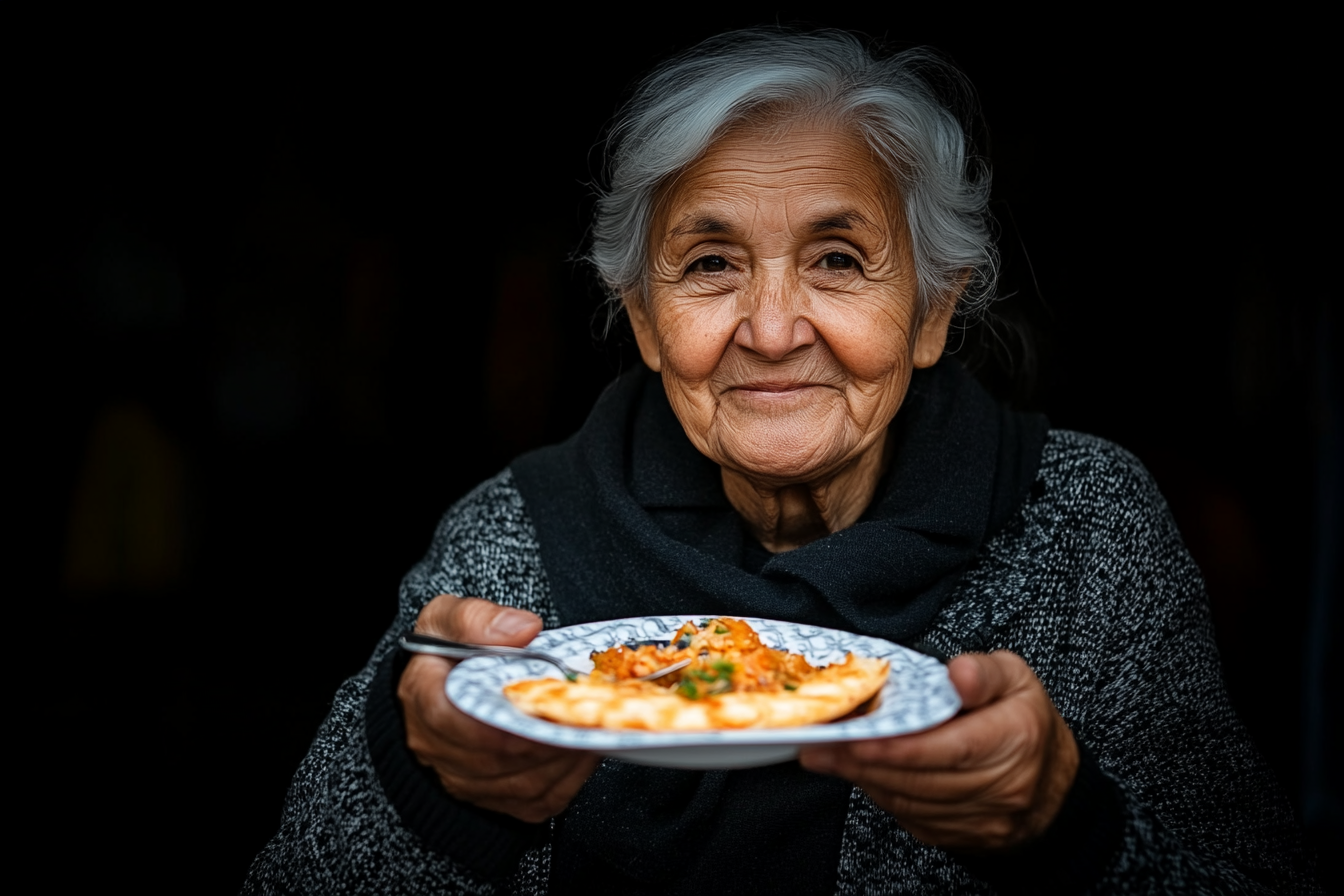 an older woman with a plate of pasta