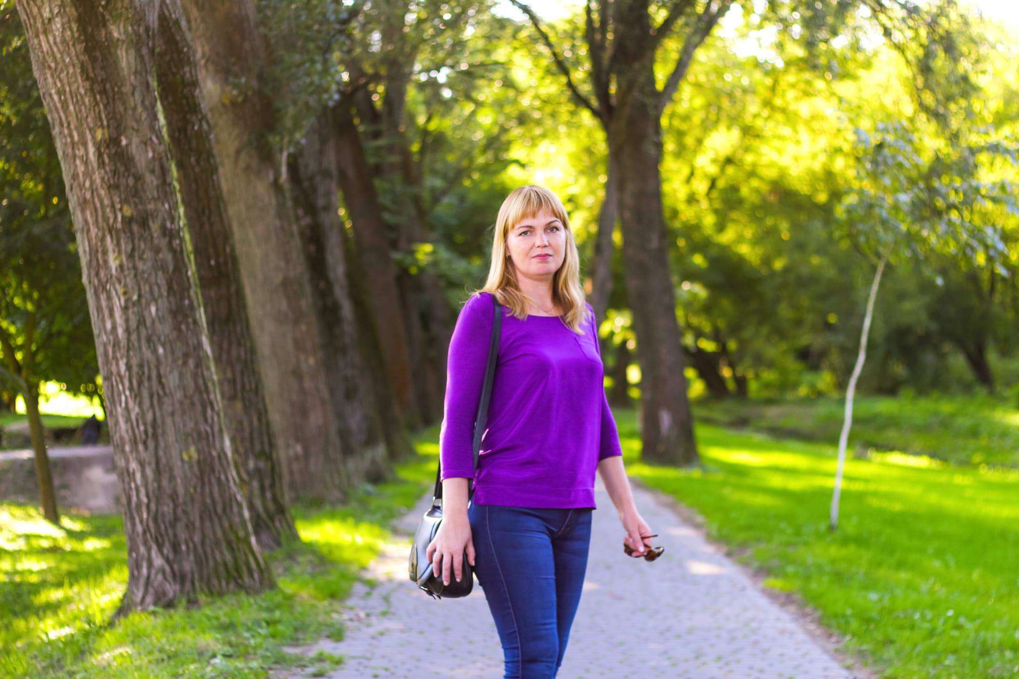 a slightly older woman walking in the park