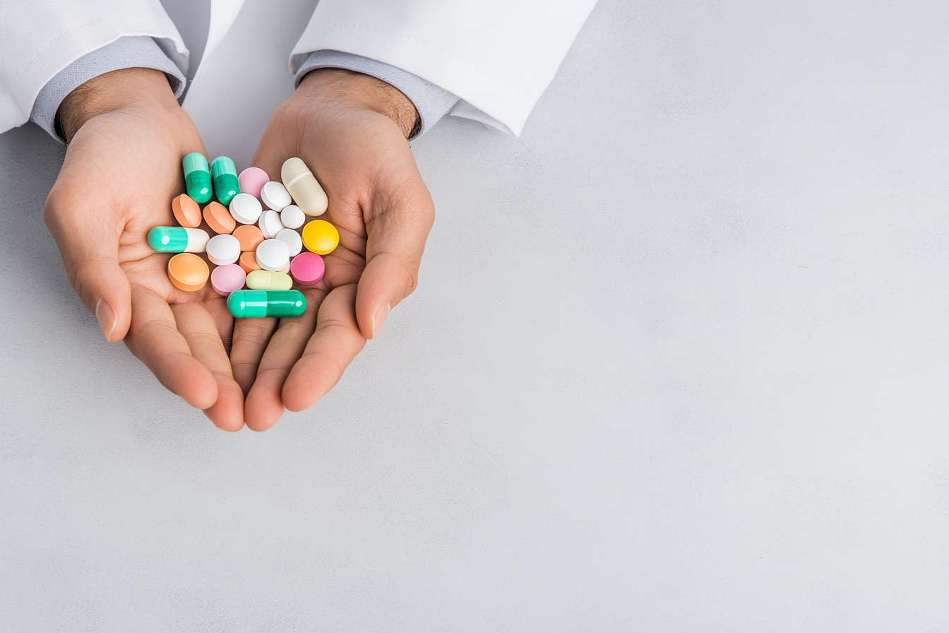A physician holding a bunch of pills - SeriousAging.com