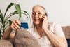 a older woman talking to a scammer on her smart phone