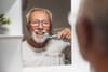 an older adult brushing their teeth as an ADL