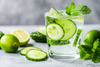 a refreshing glass of water with cucumber, lime and mint