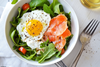 a salad with a fried egg and smoked salmon for healthy aging