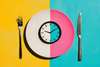 a clock on a plate symbolizing fasting for healthspan