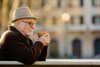 an older man in italy enjoying a cup of coffee - SeriousAging.com